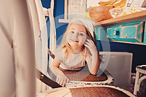 Cute happy baby girl having fun on the kitchen