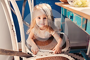 Cute happy baby girl having fun on the kitchen