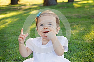 Cute happy baby girl smiling, scratching first teeth