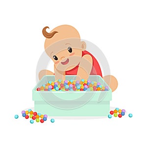 Cute happy baby sitting and playing with box full of multicolored small balls, cartoon character vector Illustration