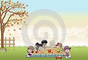 Cute happy cartoon kids playing in sandbox photo