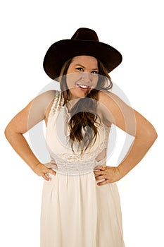 Cute happy cowgirl with her hands on her hips smiling