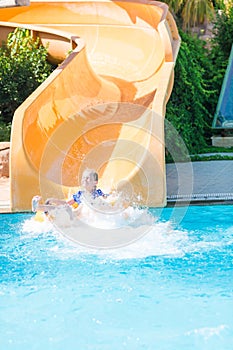 Cute happy girl in amusment aquapark