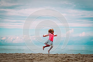 Cute happy girl dance, child play at summer beach