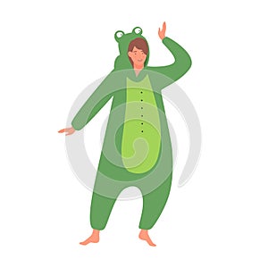 Cute happy girl in frog kigurumi costume on pajama party or sleepover