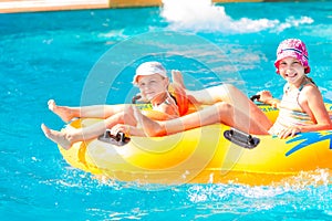 Cute happy girls in amusment aquapark