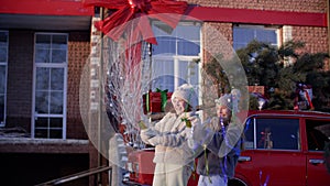 Cute happy girls having fun with Christmas crackers outdoors