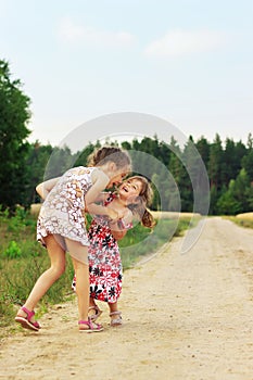 Cute happy kids playing in summer filed