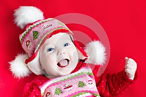 Cute happy laughing baby girl in Christmas dress a