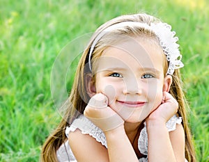 Cute happy little girl on the meadow