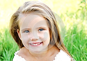 Cute happy little girl on the meadow