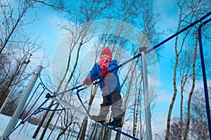 Cute happy little girl play in winter playground