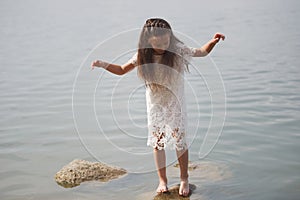 Cute happy little girl in sumer lake