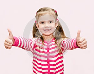 Cute happy little girl with thumbs up