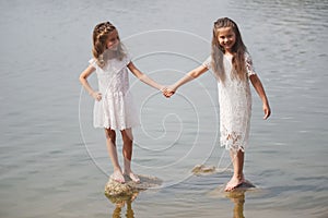 Cute happy little girls in sumer lake