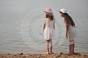 Cute happy little girls in sumer lake