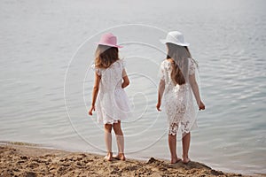 Cute happy little girls in sumer lake