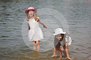 Cute happy little girls in sumer lake