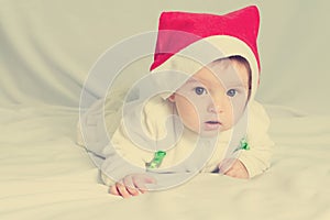 Cute happy newborn baby in christmas hat