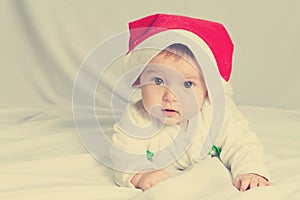 Cute happy newborn baby in christmas hat