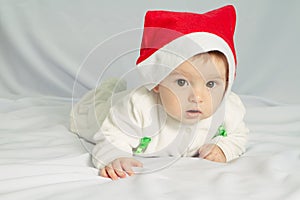 Cute happy newborn baby in christmas hat