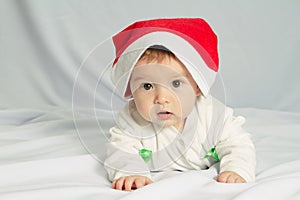 Cute happy newborn baby in christmas hat