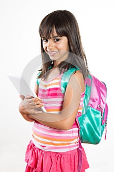 Cute and happy school girl holding a tablet