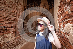 Cute happy smiling tourist girl at Wat Chaiwatthanaram is a Buddhist temple photo