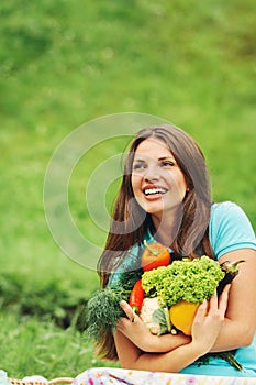 Cute happy woman with organic healthy vegetables