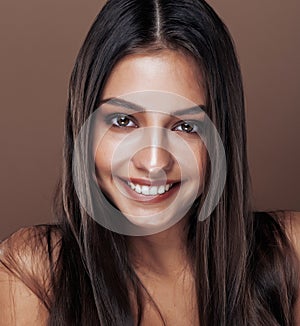 Cute happy young indian woman in studio close up smiling, fashion mulatto, lifestyle people concept