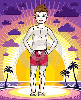 Cute happy young teen boy posing wearing fashionable beach short