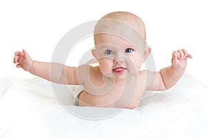 Cute healthy baby lying on white towel with hands