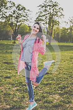 Cute hipster girl on the green meadow