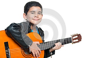 Cute hispanic boy playing an acoustic guitar