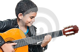 Cute hispanic boy playing an acoustic guitar