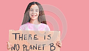 Cute hispanic child girl holding there is no planet b banner looking positive and happy standing and smiling with a confident