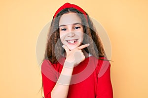 Cute hispanic child girl wearing casual clothes and diadem looking confident at the camera smiling with crossed arms and hand