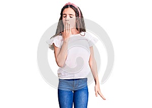 Cute hispanic child girl wearing casual white tshirt bored yawning tired covering mouth with hand