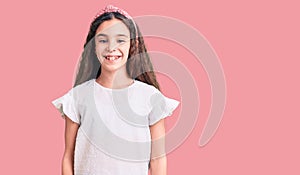 Cute hispanic child girl wearing casual white tshirt with a happy and cool smile on face