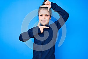 Cute hispanic child wearing casual clothes smiling making frame with hands and fingers with happy face