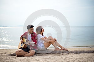 Cute hispanic couple playing guitar serenading