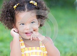 Cute hispanic girl with an afro hairstyle laughing