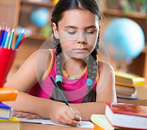 Cute hispanic girl in classroom at school