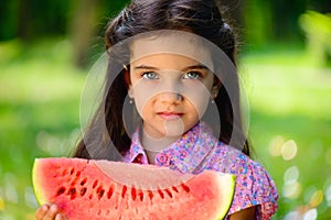 Cute hispanic girl eating watermelon