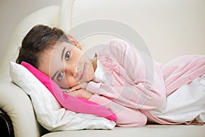 Cute hispanic girl lying in bed photo