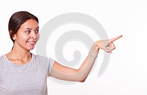 Cute hispanic lady pointing to her left