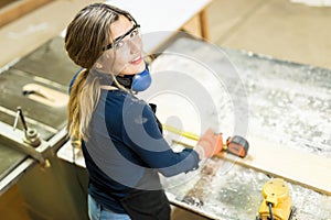 Cute Hispanic woman doing some woodwork