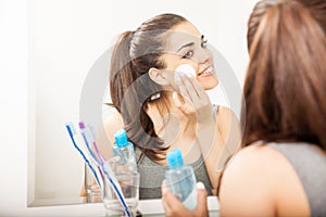 Cute Hispanic woman removing her makeup photo