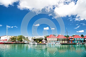 Cute houses with yacht, boat at harbor, St. John, Antigua