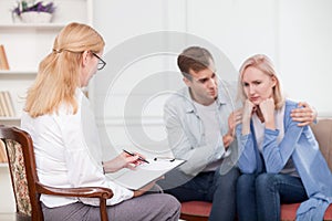 Cute husband and wife are trying marriage therapy